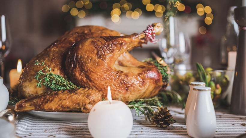 Roasted turkey on table with candles